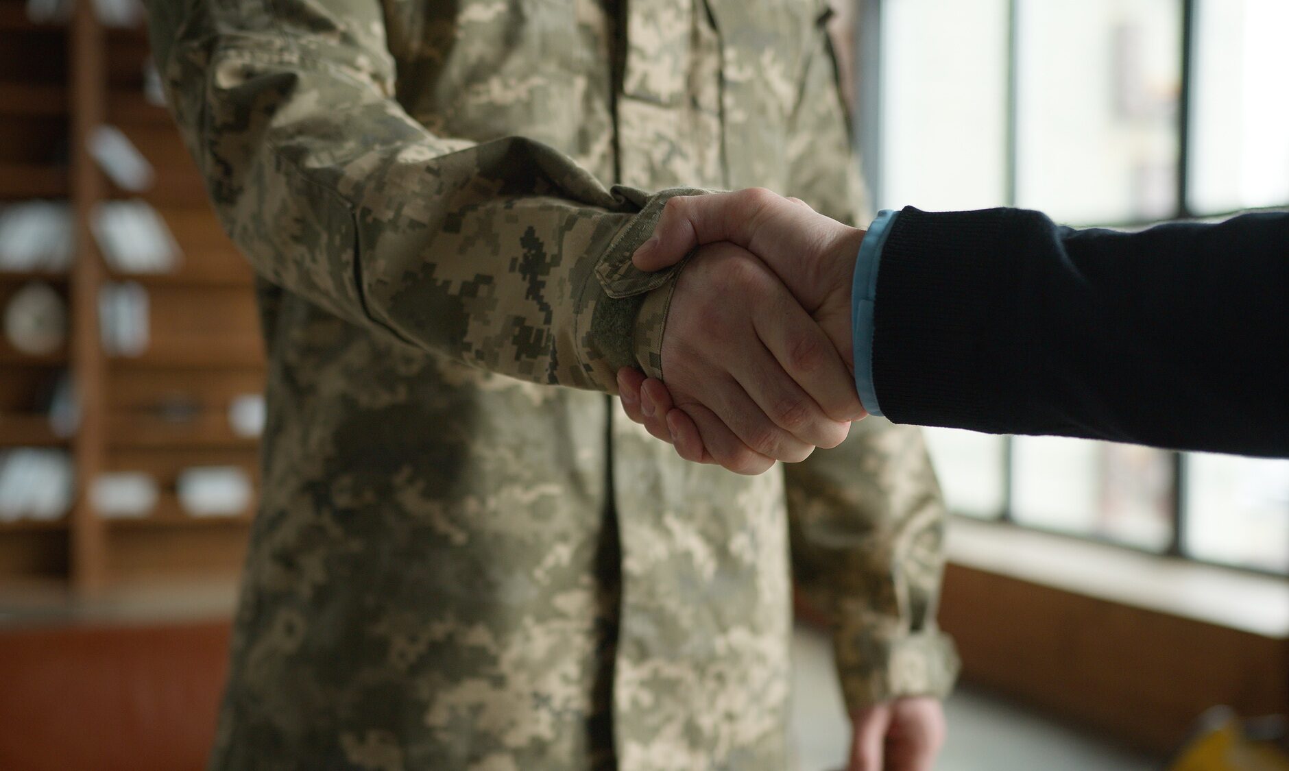 Unknown Caucasian male officer camouflage uniform guy man military army soldier veteran handshake